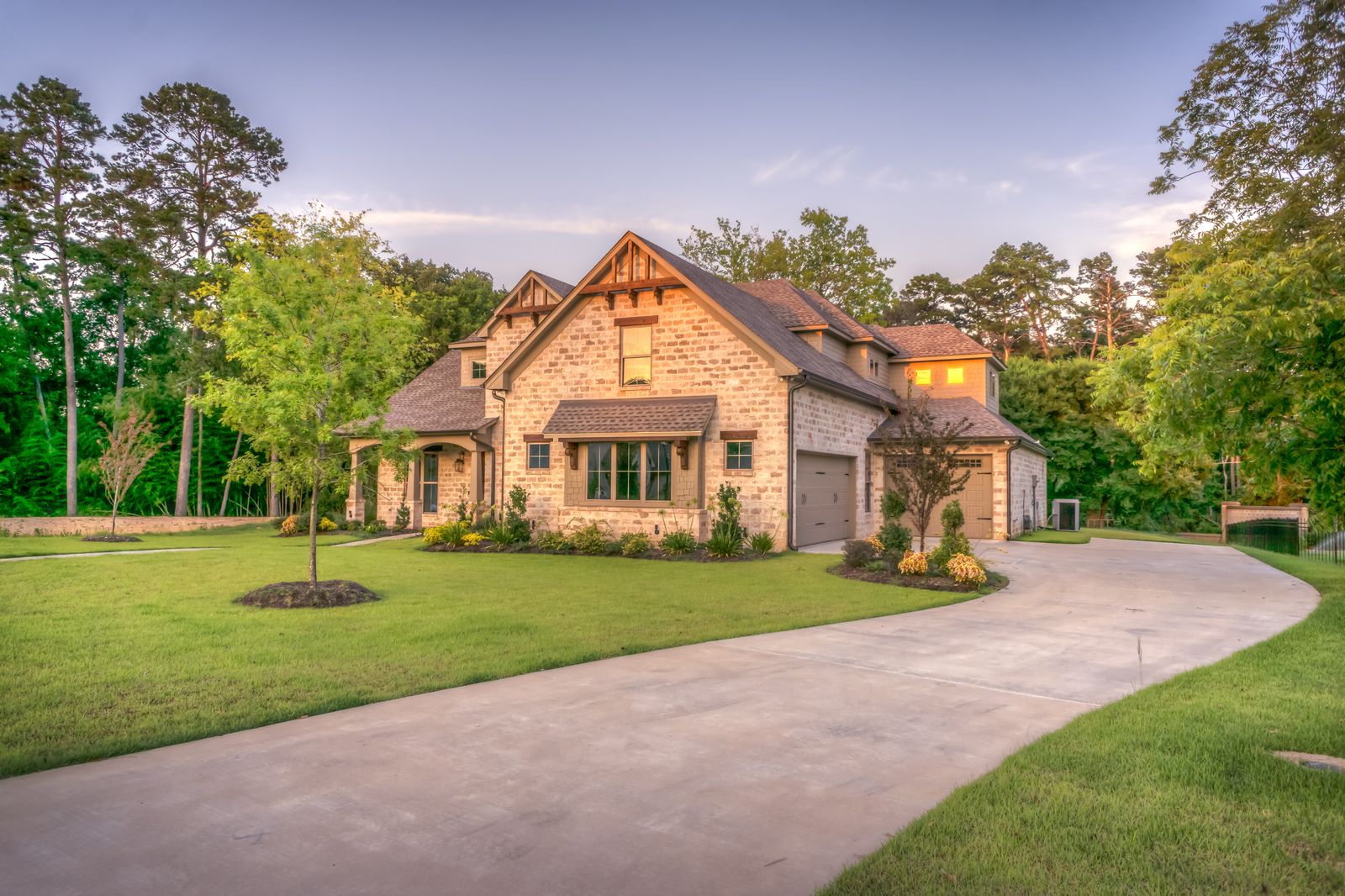 Home with a finished driveway and landscaped approach
